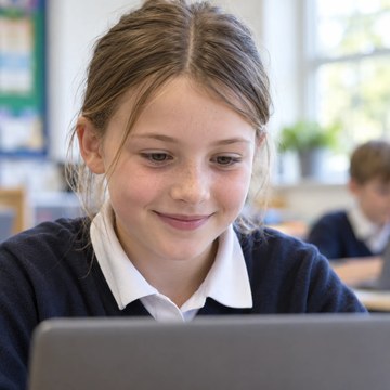 A primary school student in England at a laptop