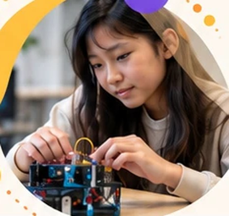 A student adjusting a small robot